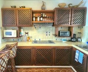 a kitchen with wooden cabinets and a counter top at Condumel in Cozumel