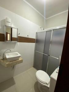 a bathroom with a toilet and a sink at chick nina in Barra do Garças