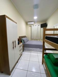 a bedroom with a bed and a bunk bed at chick nina in Barra do Garças