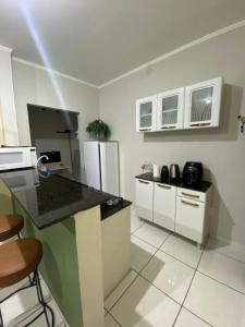 a kitchen with a refrigerator and a counter top at chick nina in Barra do Garças