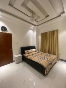 a bedroom with a bed and a dresser at Mira Transient in Bantay