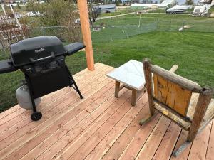 a grill and a bench on a wooden deck at LakeView Landing - Stunning Views Overlooking Bay in Big Arm