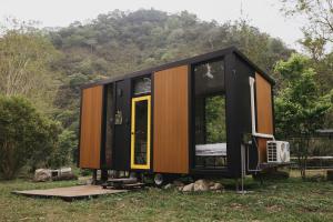 a tiny house on a trailer in a field at Lanyin Hut in Shui-t'ien
