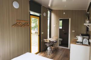 a room with a bed and a kitchen with a table at Lanyin Hut in Shui-t'ien +16 photos