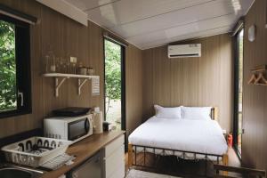 a bedroom with a bed and a tv in a room at Lanyin Hut in Shui-t'ien