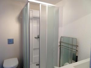 a bathroom with a toilet and a glass shower at Stone House in Bricqueville near Sandy Beach in Bricqueville-sur-Mer +16 photos