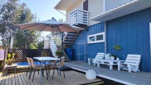 a patio with an umbrella and a table and chairs at Lily Home in Algarrobo