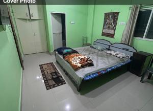 a bedroom with a bed in a green room at Sagar hotel and guest house in Sāgar