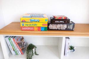 a shelf with books and other items on it at The Gables Berry in Berry