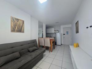 a living room with a couch and a table at Apto. 1 dorm. no Edf. Manhattan home service 605 in Caruaru