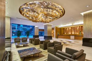 a lobby with chairs and a large chandelier at Four Points by Sheraton Shanghai, Daning in Shanghai