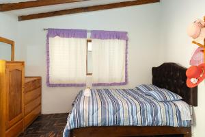 a bedroom with a bed and a window at Perfect Rest in Urubamba in Urubamba