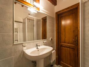a bathroom with a sink and a mirror at Mansion with Pool and play area in Pian di Scò +88 photos