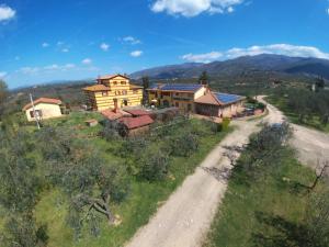 an aerial view of a house and a dirt road at Mansion with Pool and play area in Pian di Scò