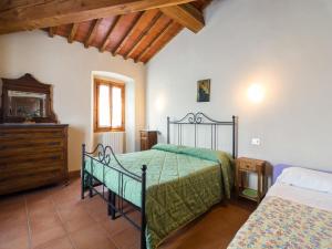 a bedroom with two beds and a dresser in it at Mansion with Pool and play area in Pian di Scò