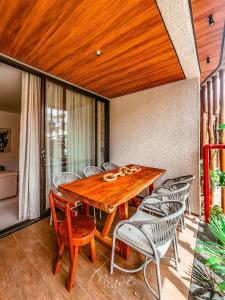 a dining room with a wooden table and chairs at Naay - Sun 008 in Pôrto de Pedras