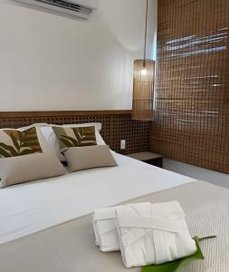 a bedroom with a large bed with a white bedspread at Naay - Sun 008 in Pôrto de Pedras +58 photos