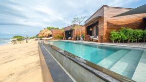 a house with a swimming pool next to a beach at Sea Sun Beach Villa in Nusa Lembongan +37 photos