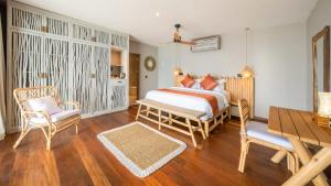 a bedroom with a bed and a table and chairs at Sea Sun Beach Villa in Nusa Lembongan