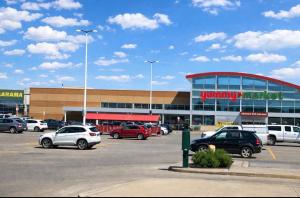 a parking lot with cars parked in front of a shopping center at Quite Cozy Private Room In Vaughan with Private Bathroom and Free Parking in Vaughan
