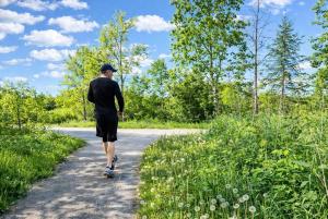 a man riding a skateboard down a road at Quite Cozy Private Room In Vaughan with Private Bathroom and Free Parking in Vaughan