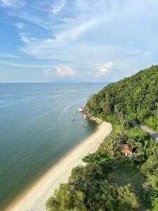 an aerial view of a beach and the ocean at Angsana Teluk Bahang, Penang in Batu Ferringhi