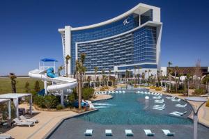 a resort with a water slide in front of a building at Choctaw Casino & Resort Durant, a Wyndham Grand Hotel in Durant