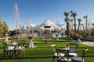 a group of tables and chairs in a field with a tent at Choctaw Casino & Resort Durant, a Wyndham Grand Hotel in Durant