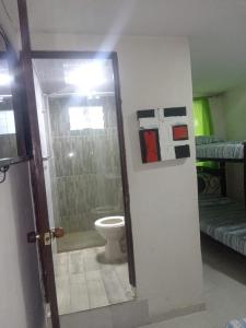 a bathroom with a shower and a toilet in a room at Hostal Sur Tosc in Cali