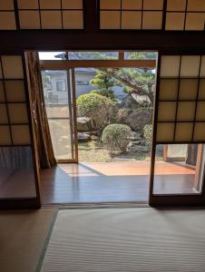 an open door with a view of a garden at Y House in Kurashiki