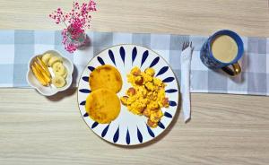 a plate of food with eggs and a cup of coffee at Hammocks - Hamacas in Ríohacha +14 photos