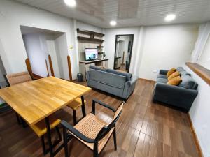 a living room with a table and chairs and a couch at Cusco Center Apartment in Cusco