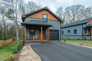 a house with a driveway and a garage at Roam Inn in Black Mountain