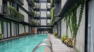 an indoor swimming pool in a building with plants at Park 5 Cilandak in Jakarta