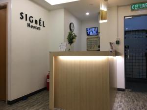 an office with a reception desk and a door at Signel Hostel in Kota Kinabalu