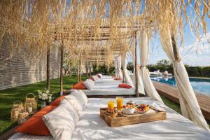 a long row of tables with food on them at Jnan Lotf Marrakech - Le Jardin de la Bienveillance in Marrakesh