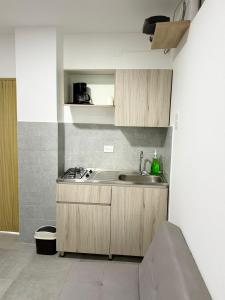 a kitchen with wooden cabinets and a sink at Diplastic House in Sincelejo