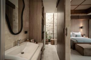 a bathroom with a bath tub and a bed at La Vie Villa Seminyak by Ini Vie Hospitality in Seminyak +33 photos