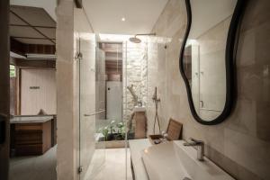 a bathroom with a sink and a mirror at La Vie Villa Seminyak by Ini Vie Hospitality in Seminyak