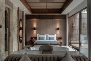 a hotel room with a bed and a tub at La Vie Villa Seminyak by Ini Vie Hospitality in Seminyak