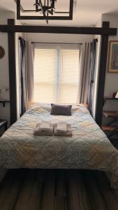 a bedroom with a bed with two towels on it at Private Rooms, Shared Bath in a Private Home Minutes From Logan Airport in Boston