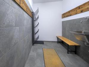 a bathroom with a sink and a bench at Alpine Chalet with Ski-In Access in Neukirchen am Großvenediger +44 photos