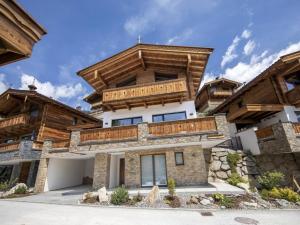 a house with a balcony on top of it at Alpine Chalet with Ski-In Access in Neukirchen am Großvenediger