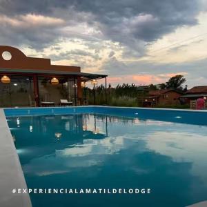 a large swimming pool in front of a house at La Matilde Lodge in San Bernardino