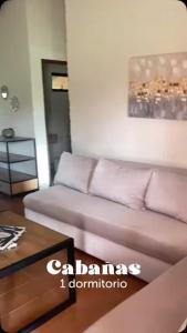 a living room with a couch and a table at La Matilde Lodge in San Bernardino