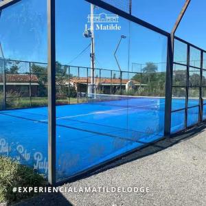 a reflection of a tennis court in a building at La Matilde Lodge in San Bernardino