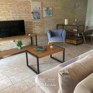 a living room with a couch and a coffee table at La Matilde Lodge in San Bernardino
