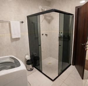 a shower with a glass door in a bathroom at Flat Completo - Cozinha - Lavadora - Climatizado in Erval dʼOeste +6 photos