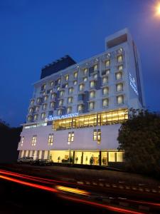 a large white hotel with lights on the side of it at The Central Residency in Trivandrum