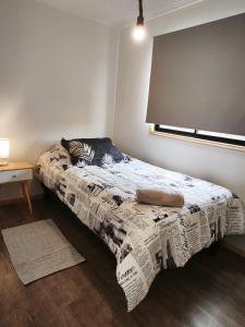 a bedroom with a bed with a blanket on it at Cabañas Lodge el Mauco in Curacaví +18 photos